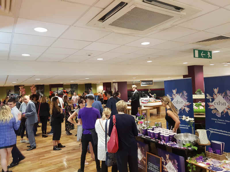 Sector-focused business networking crowd in conversation inside a central Manchester bar