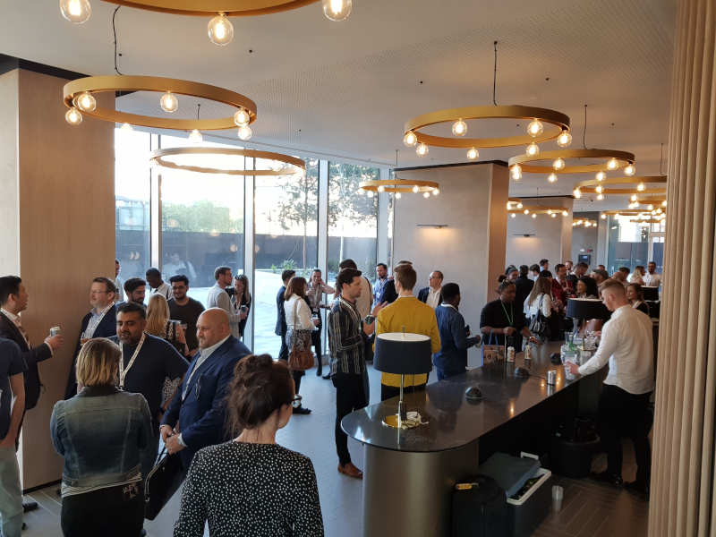 Professionals mingling on a rooftop bar terrace at a Manchester Happy Hour Networking evening event